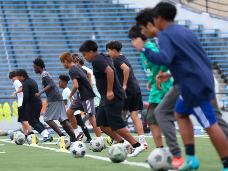 Soccer Showcase II — team dribbling drill on field