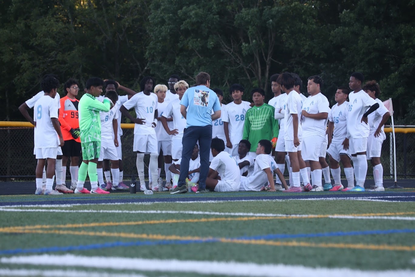 Soccer Showcase II — team huddle with coach