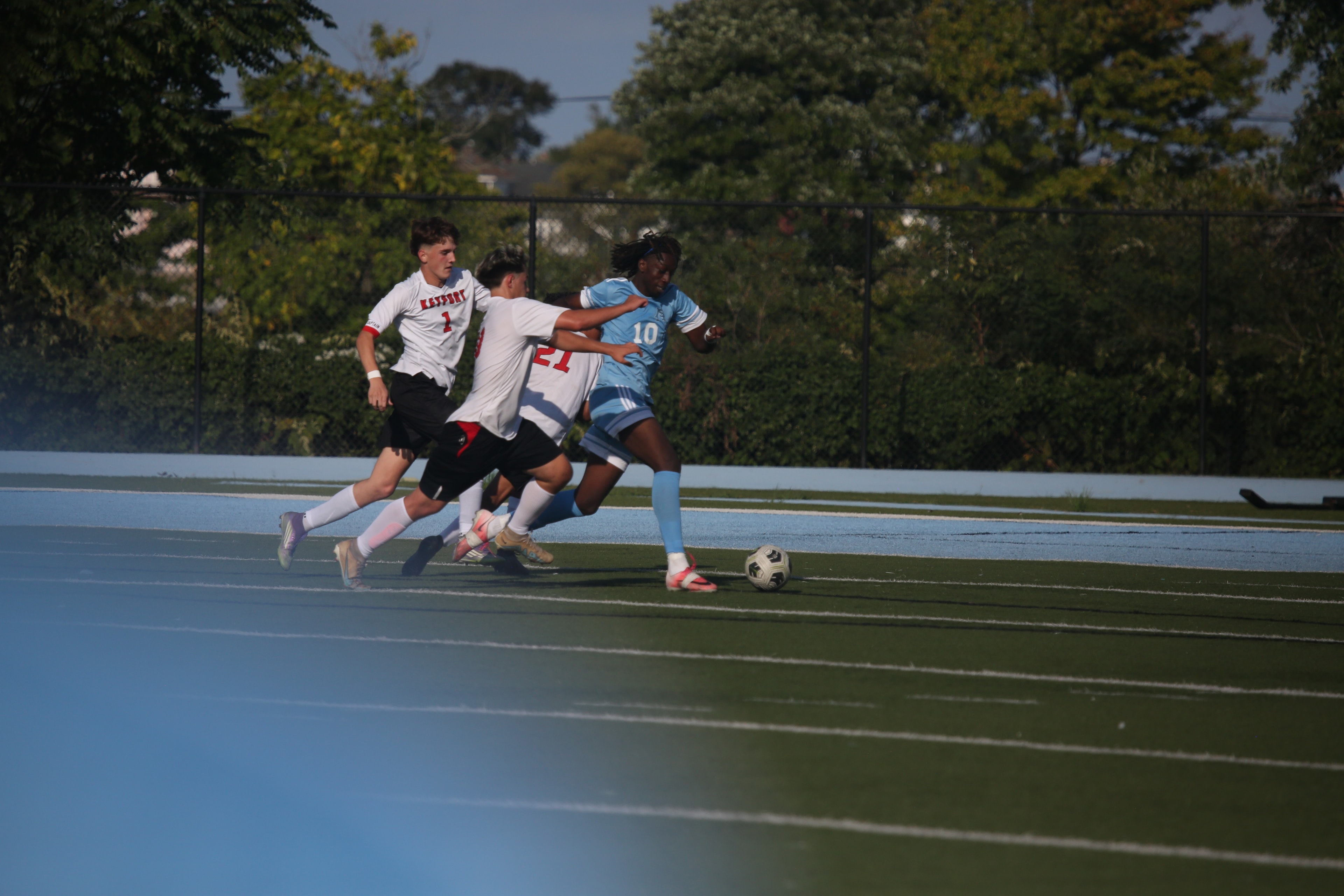 Asbury Park United player driving past defenders